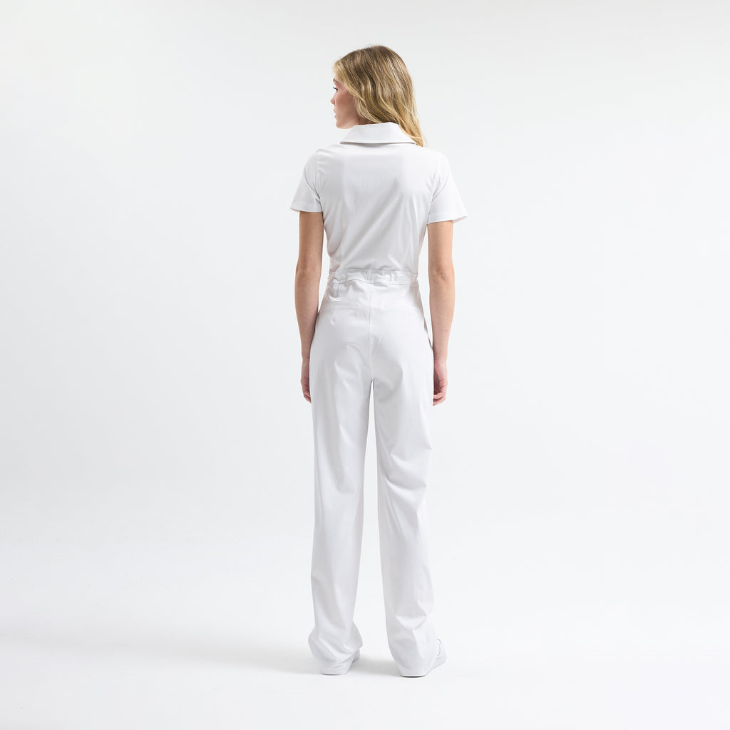 White scrub tulum back view, short sleeves, drawstring waist, full-length legs.