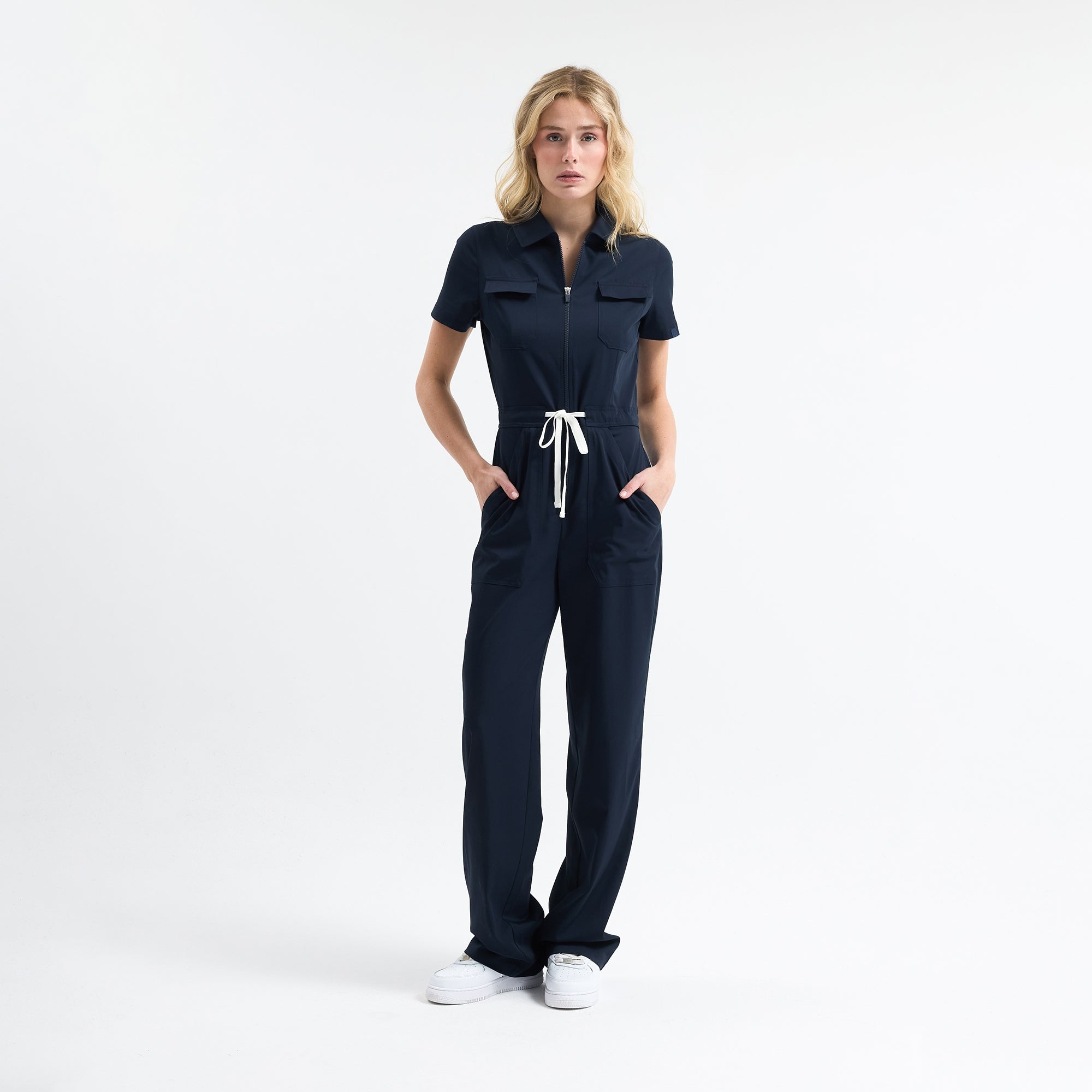 Navy scrub jumpsuit, front zip, short sleeves, chest pockets, tie waist