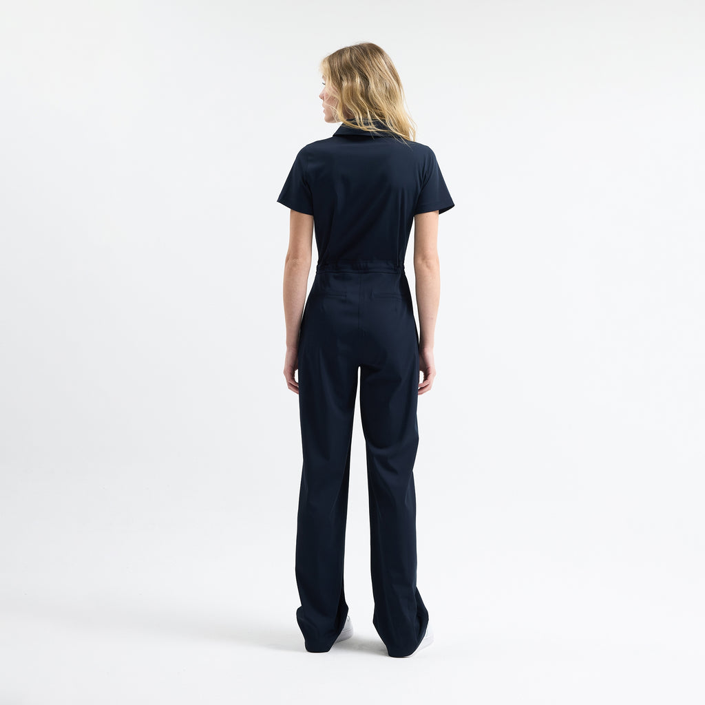Navy scrub jumpsuit back view, drawstring waist, wide leg