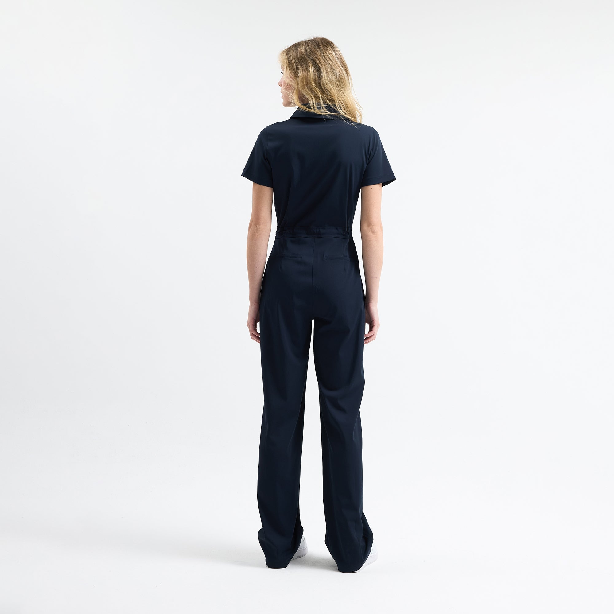 Navy scrub jumpsuit back view, drawstring waist, wide leg