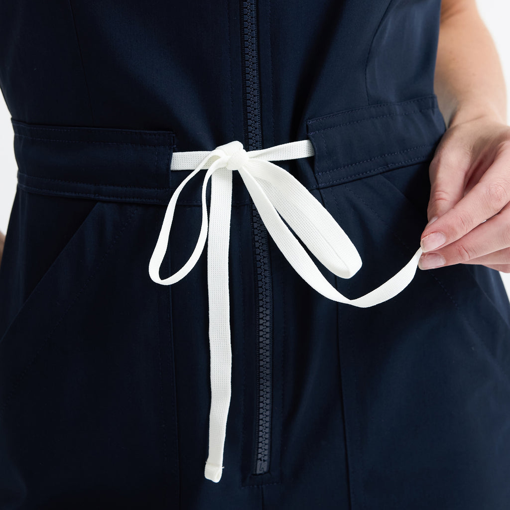 Navy scrub jumpsuit waist tie and front zipper detail