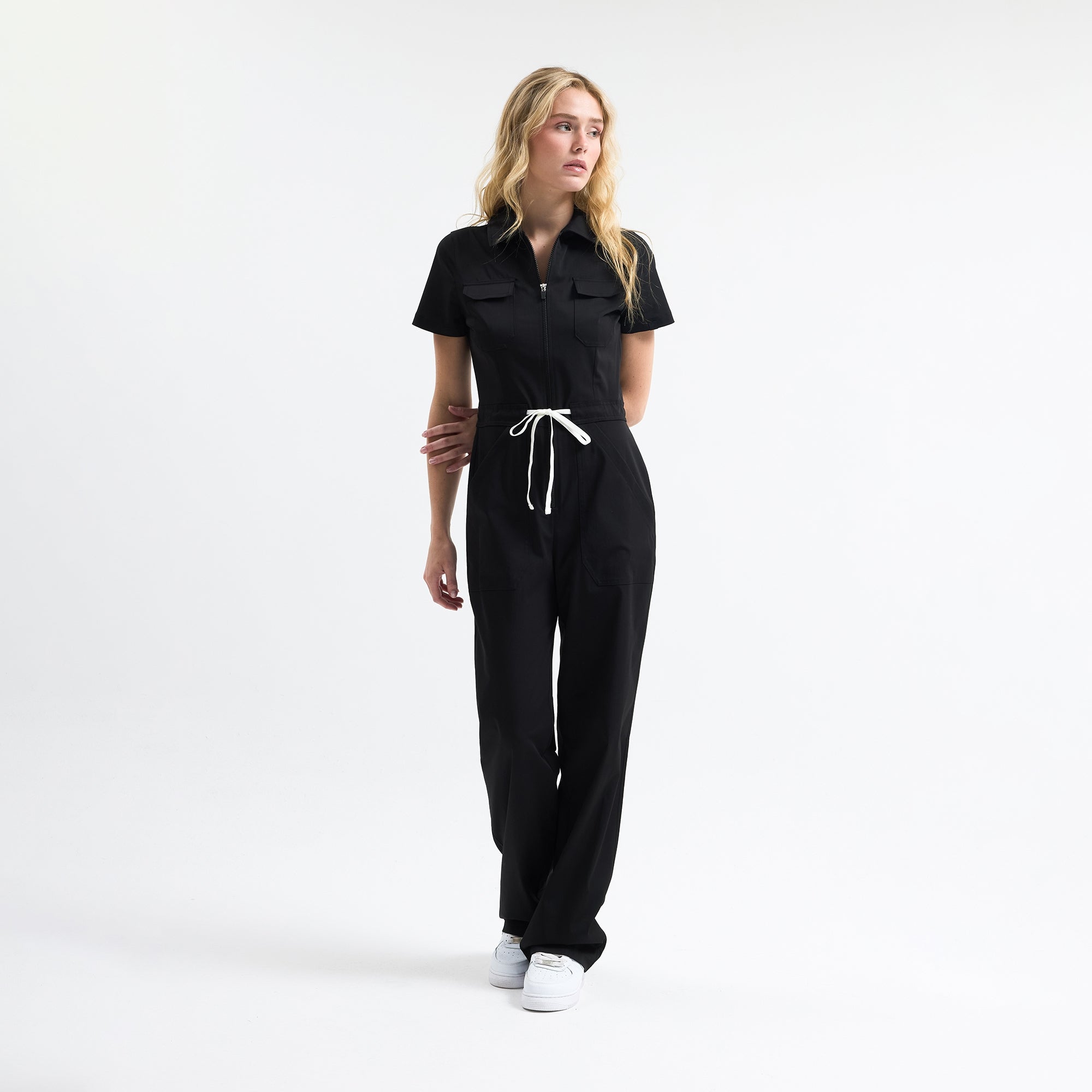 Serene black scrub tulum with short sleeves, chest pockets, and drawstring waist
