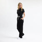 Serene black scrub tulum side view with drawstring waist and wide straight legs