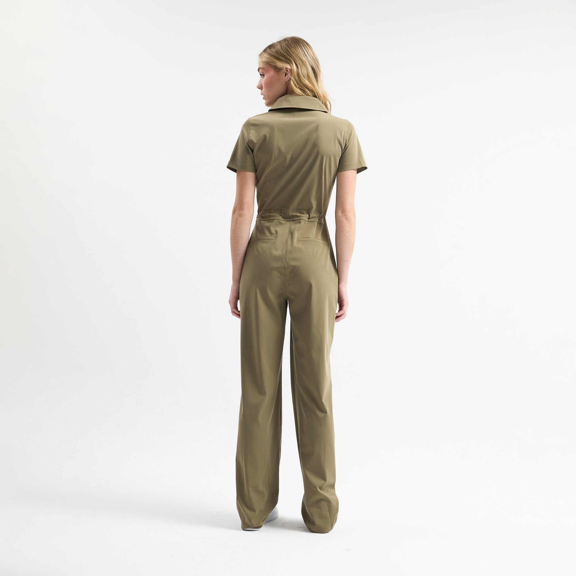 Hunter green scrub tulum back view on model, short sleeves, tie waist