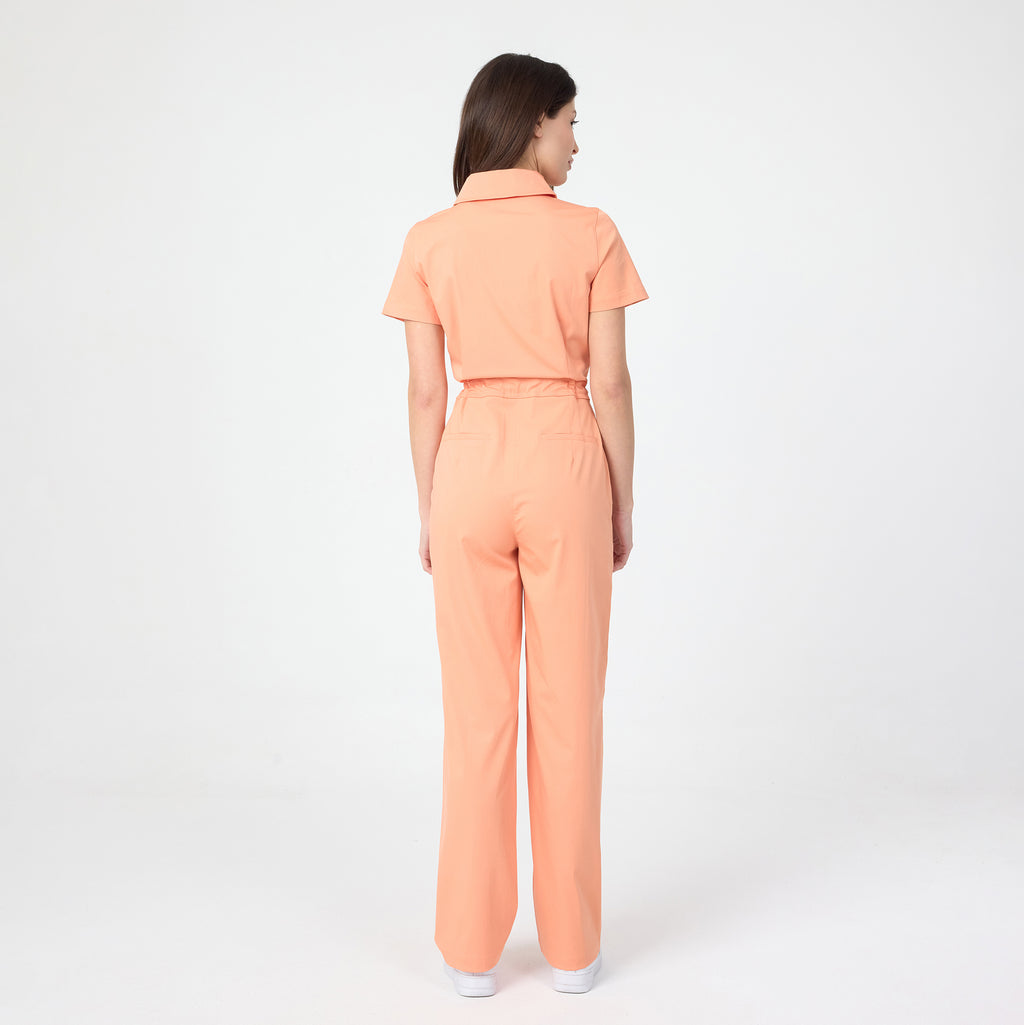 Tangerine scrub tulum back view with short sleeves and waist seam