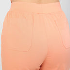 Tangerine scrub pants back with elastic waist and two patch pockets