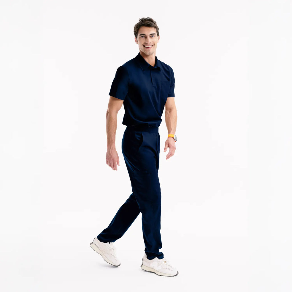 Arrow Navy scrub pantolon, dizden bol kesim ve ön cep detayları