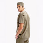 Halo green scrub top with short sleeves and chest pocket, side view