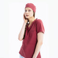 Maroon scrub top with V-neck, chest pocket and matching scrub cap