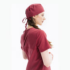 Maroon scrub top and cap, side view with back ties at hood