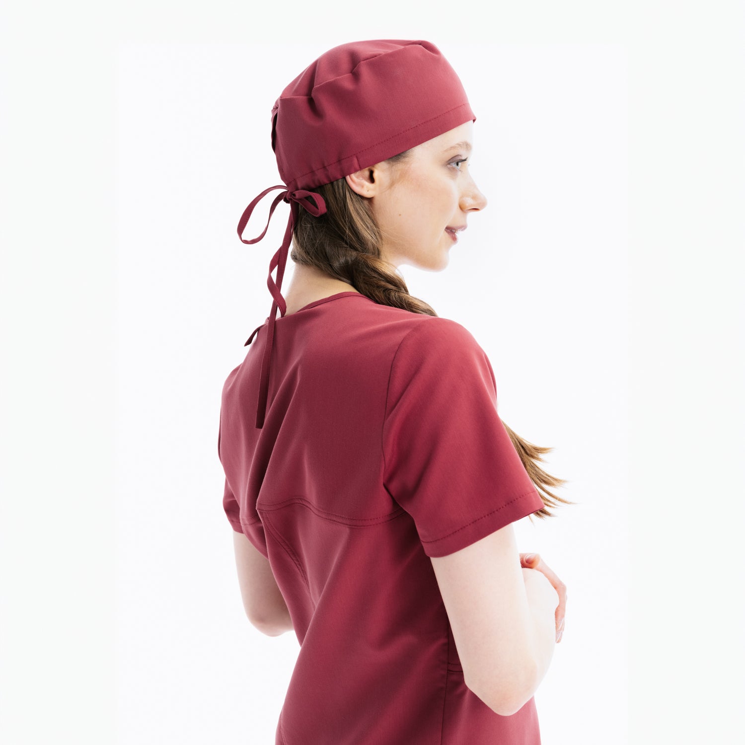 Maroon scrub top and cap, side view with back ties at hood