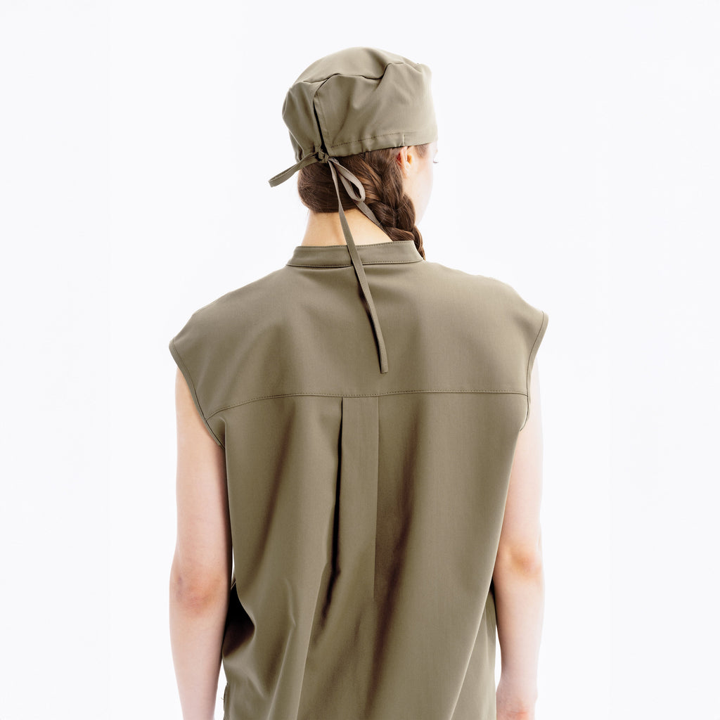 Hunter green sleeveless scrub top back view with banded collar and center seams