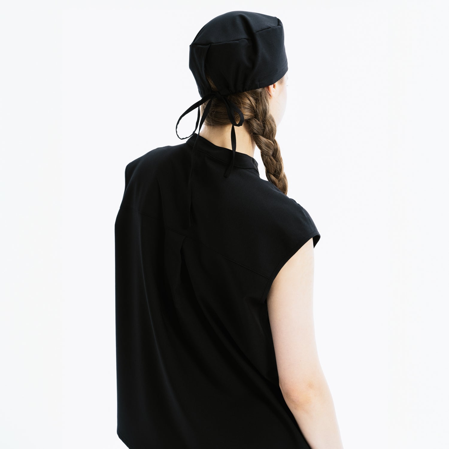 Black scrub top back view with high collar and scrub cap tie detail