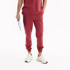 Chili renkli jogger scrub pantolon; yan cepler ve ayarlanabilir pa lastiği